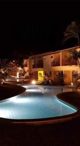 a large swimming pool with lights in front of a building at Solar Águas Pipa Prime in Pipa
