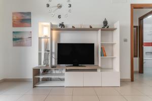 a television on a white entertainment center in a living room at Casa More Alcalá Center in Alcalá