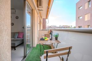 an apartment balcony with a table and a couch at Casa More Alcalá Center in Alcalá
