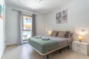 a bedroom with a large bed and a window at Casa More Alcalá Center in Alcalá