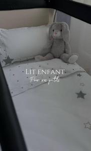 a teddy bear sitting on top of a bed at Elena 100 m2 in Marseille
