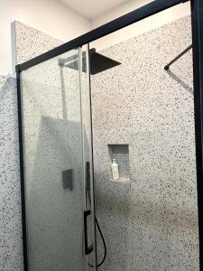 a shower with a glass door in a bathroom at Paris 16 lux and cozy 2 bedroom in Paris