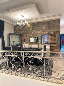 a living room with a stone wall and a table at Hotel Duplex Front of DownTown in Cairo