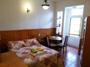 a bedroom with a bed and a table and a table at Comarca Valparaíso in Valparaíso