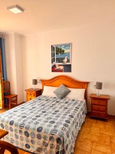 a bedroom with a bed and two night stands and two lamps at Villa Mercè Empúries in Sant Martí d’Empúries