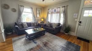 a living room with a couch and a coffee table at Historic Home w/Pikes Peak Views in Colorado Springs