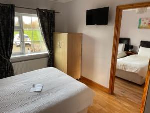 Ліжко або ліжка в номері Padua Guest Accommodation Rosslare