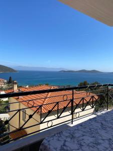 a balcony of a house with a view of the ocean at Ellis-Suites Nea Peramos Kavala in Nea Peramos