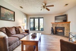 a living room with a couch and a fireplace at Secluded Sevierville Condo with Hot Tub and Mtn Views! in Sevierville