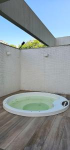 a large tub in a room with a wall at Option Full Service Residence in Rio de Janeiro