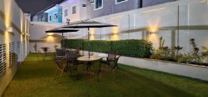 a patio with a table and chairs and umbrellas at Option Full Service Residence in Rio de Janeiro