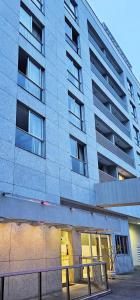 a tallartment building with a staircase in front of it at Option Full Service Residence in Rio de Janeiro