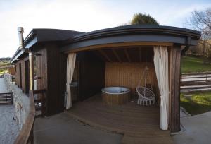 a gazebo with a tub on a deck at Cabañas O Recuncho do Sor in O Barqueiro