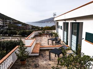 a house with a balcony with a view of the ocean at Villa La Quiete - Adults only in Ksamil