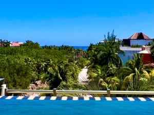 a view of the beach from a resort swimming pool at Spacious Penthouse w/ Private Pool & Maid Service in Puerto Morelos