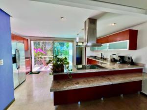 a kitchen with red cabinets and a counter top at Spacious Penthouse w/ Private Pool & Maid Service in Puerto Morelos