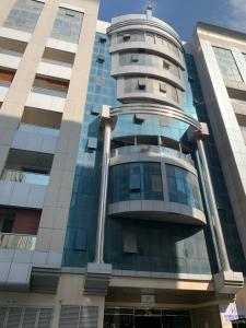 a tall building with a dome on top of it at Ramble stay Hostel Bur Dubai in Dubai