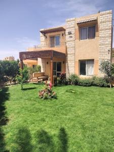 a house with a lawn in front of it at العين السخنة in Ain Sokhna