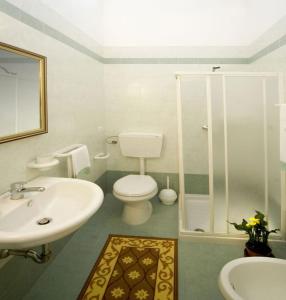 a bathroom with a toilet and a sink at B&B Vigna La Corte in Alessano