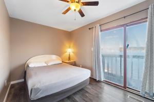 a bedroom with a bed and a large window at Lazy Gator House- Sleep 20- Bachelor Parties Welcome in Lake Ozark