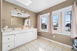 a bathroom with a sink and a mirror at Lazy Gator House- Sleep 20- Bachelor Parties Welcome in Lake Ozark