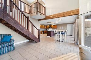 a large living room with a staircase and a kitchen at Lazy Gator House- Sleep 20- Bachelor Parties Welcome in Lake Ozark