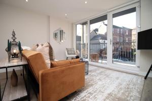 a living room with a couch and a large window at Casablanca 4 - Cardiff Bay - 2 Bed Apartment in Cardiff