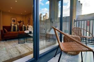 a living room with a couch and chairs on a balcony at Casablanca 4 - Cardiff Bay - 2 Bed Apartment in Cardiff