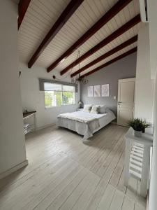 a large bedroom with a bed and a wooden floor at Apart del Centro in Esquina