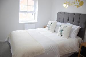 a bedroom with a large white bed with white pillows at Orient Oasis Yarm in Stockton-on-Tees