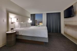 a hotel room with a bed and a large window at Crowne Plaza Hotel Dallas Downtown, an IHG Hotel in Dallas