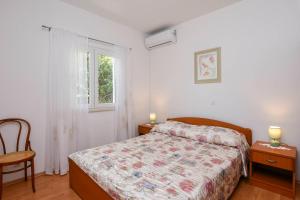 a bedroom with a bed and a window at Apartments Goga in Orebić