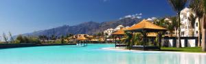 a large pool of blue water in a resort at Rok Plaza in Alcalá