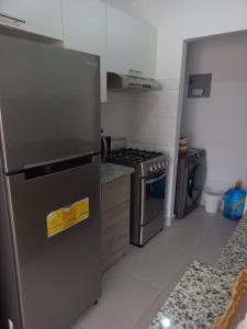 a kitchen with a stainless steel refrigerator and a stove at Pool Breeze 202 in Punta Cana