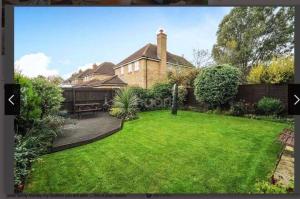 a garden in front of a house with a lawn at 5 star, 5 Bedroom Home in Ely in Ely