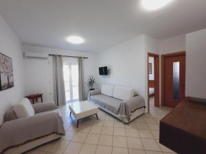 a living room with a couch and a table at Amarildo Hotel in Himare