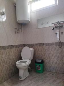 a bathroom with a toilet and a water tank at Hostel Yak-Shab in Dushanbe