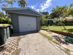 a garage in the front of a house at Camelot in Yamba