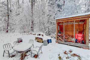 a cabin with a table and chairs in the snow at Fantasia in Alton Bay