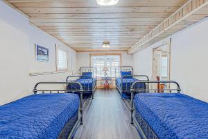 two bunk beds in a room with blue beds at Fantasia in Alton Bay