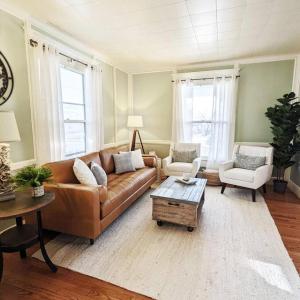 a living room with a couch and two chairs at Stylish Victorian in Historic District in Cambridge
