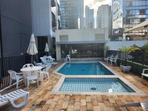 a swimming pool on the roof of a building at Apart hotel Champagnat in Belo Horizonte
