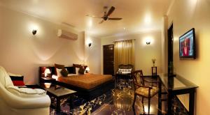 a living room with a bed and a couch at Perch Arbor Suites in Gurgaon