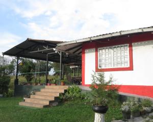 a red and white building with a black roof at HOTEL PURA VIDA in Santa Rosa de Cabal