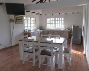 a kitchen with a white table and chairs at HOTEL PURA VIDA in Santa Rosa de Cabal