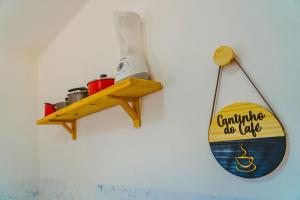 a surfboard holder on a wall with a surfboard on it at Chale c WiFi e excelente localizacao-Parnaiba in Parnaíba