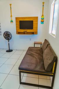 ein Wohnzimmer mit einem Sofa und einem Flachbild-TV in der Unterkunft Incrivel chale c WiFi e boa localizacao - Parnaiba in Parnaíba