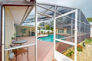 an external view of a swimming pool through a glass enclosure at Evergreen Escape in Orlando