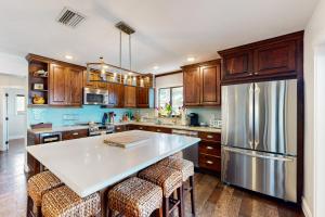 uma cozinha com armários de madeira e um frigorífico de aço inoxidável em The Colorful Cabana em Key Largo