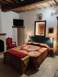 a bedroom with a bed with a red comforter at Dimora Storica in Petrignano